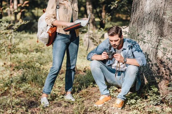 Partial view of couple of travelers with map and photo camera in park — Stock Photo