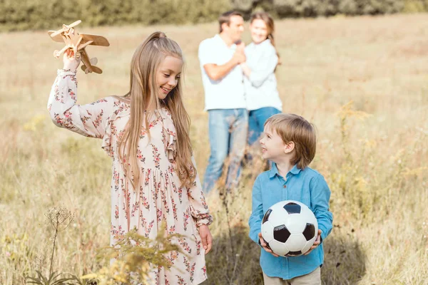 Beautiful young family spending time together in nature — Stock Photo