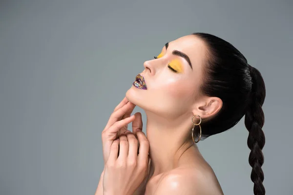 Side view of sensual brunette girl with stylish makeup and closed eyes isolated on grey — Stock Photo