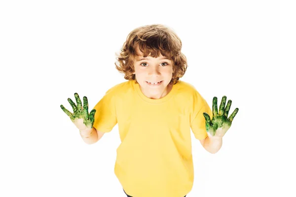 Vista de ángulo alto adorable niño feliz con las manos en la pintura sonriendo a la cámara aislada en blanco - foto de stock