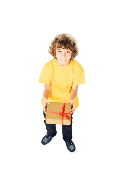 High angle view of adorable boy holding gift box and looking at camera isolated on white — Stock Photo