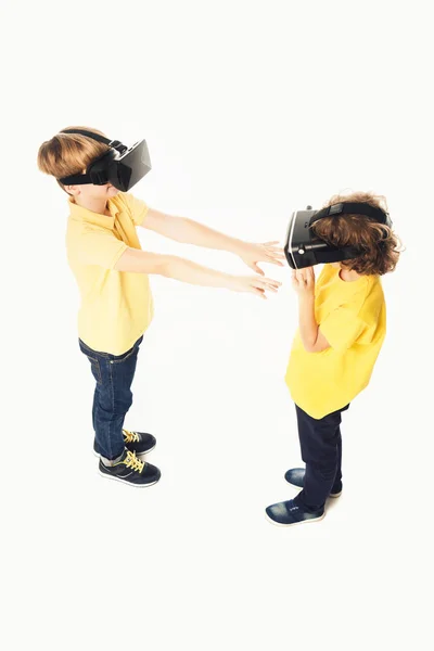Vista de ángulo alto de los niños usando auriculares de realidad virtual aislados en blanco — Stock Photo