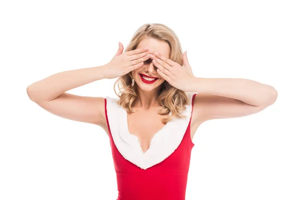Happy santa girl in christmas dress covering eyes by hands isolated on white — Stock Photo