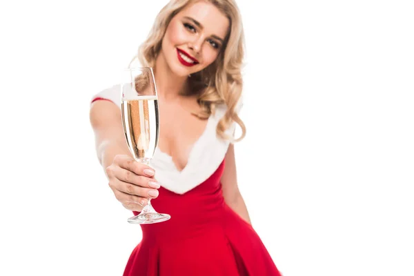 Selective focus of young woman in christmas dress showing champagne glass isolated on white — Stock Photo