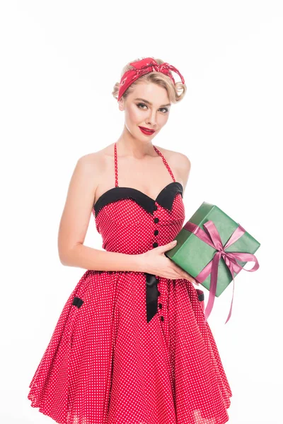 Beautiful woman in retro pin up dress standing with gift box isolated on white — Stock Photo