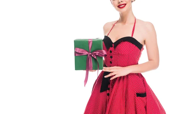 Partial view of woman in retro pin up dress showing gift box isolated on white — Stock Photo