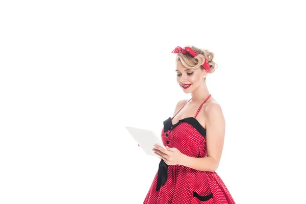 Smiling woman in pin up clothing using digital tablet isolated on white — Stock Photo