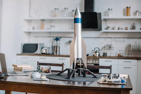 Rocket model and tools for engineering on table in kitchen — Stock Photo