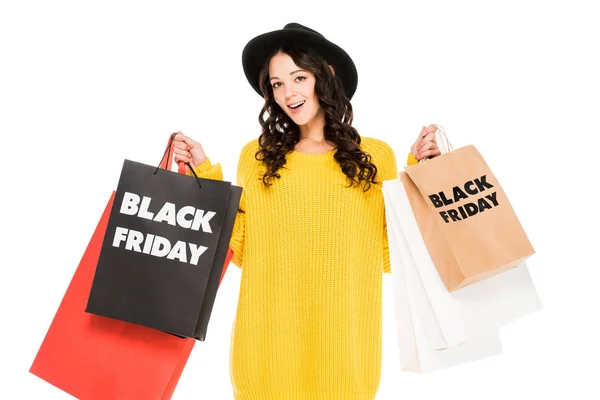 Animado elegante cliente segurando sacos de compras com símbolos de sexta-feira preta, isolado no branco — Fotografia de Stock