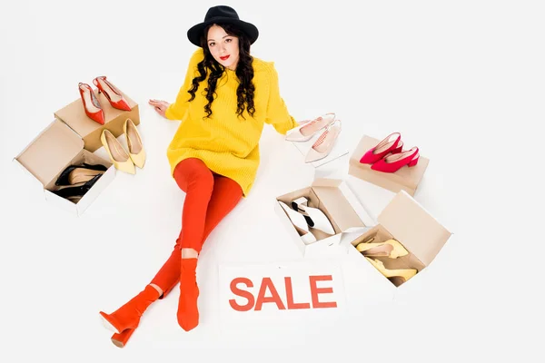 Beautiful stylish girl with sale symbol isolated on white with footwear — Stock Photo