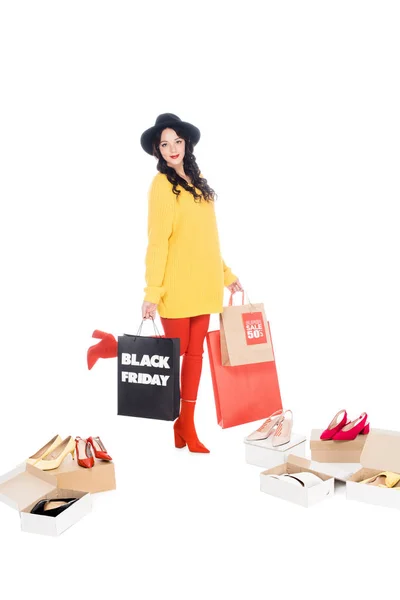 Holding shopping bags with black friday — Stock Photo