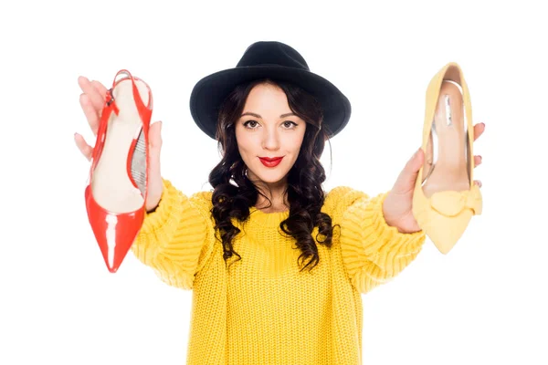 Smiling stylish girl holding high heels isolated on white — Stock Photo