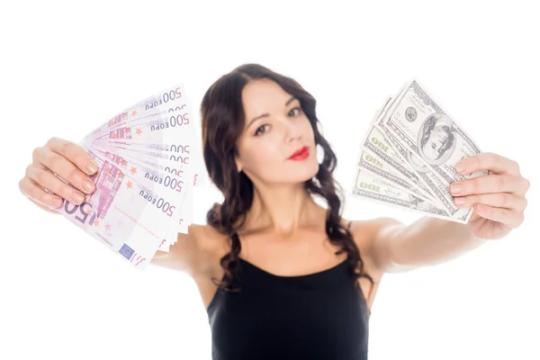 Portrait of young woman showing dollar and euro banknotes in hands isolated on white — Stock Photo