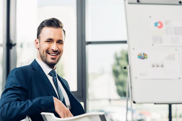 Cheerful businesssman waiting for business lecture in conference hall — Stock Photo