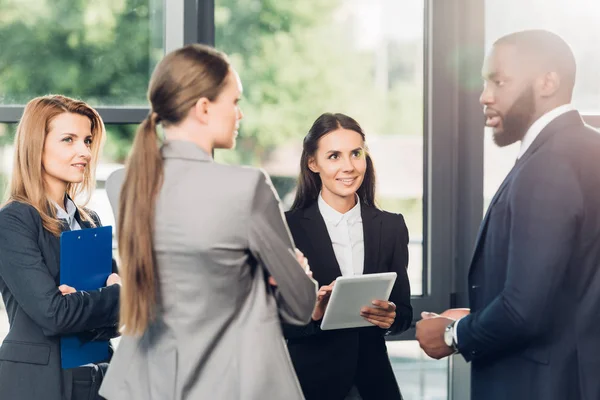 Multiethnic business colleagues having conversation in office — Stock Photo