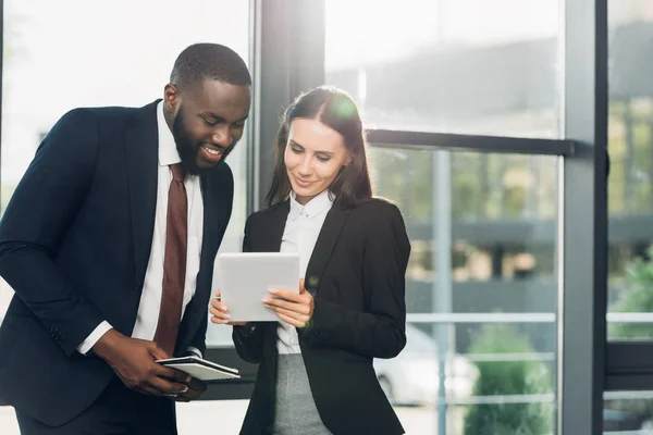 Multiracial business colleague using tablet in conference hall — Stock Photo