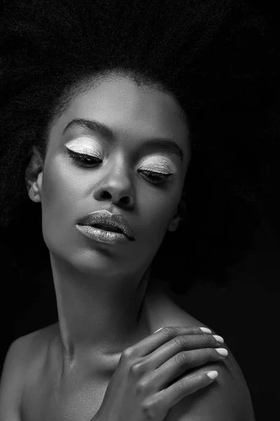 Black and white photo of attractive african american woman isolated on black — Stock Photo