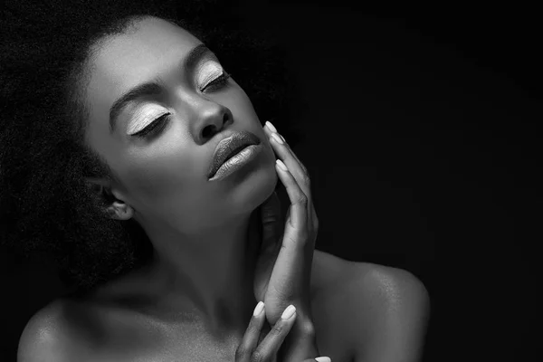Black and white photo of attractive african american woman isolated on black — Stock Photo