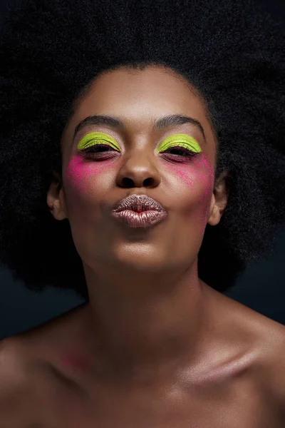 Portrait of african american model with bright neon makeup and duck face posing isolated on black — Stock Photo