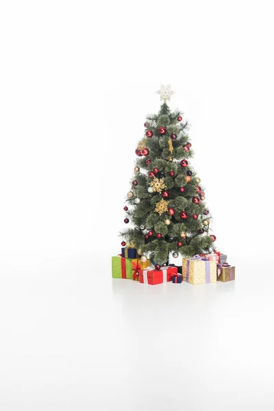 Close up view of festive christmas tree and wrapped gifts isolated on white — Stock Photo