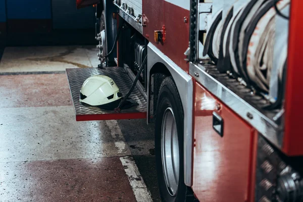 Close up view of protective helmet on fire truck at fire station — Stock Photo