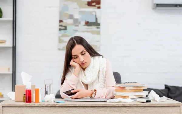 Overworked sick young woman sleeping at messy workplace — Stock Photo