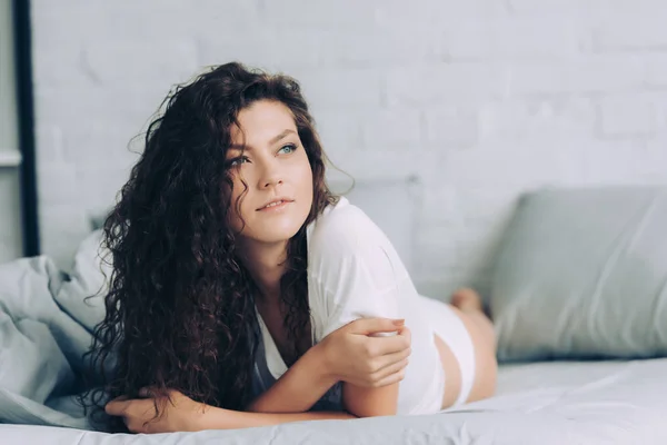 Young woman laying in bed during morning time at home — Stock Photo