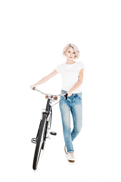 Attractive young adult woman with bicycle isolated on white — Stock Photo