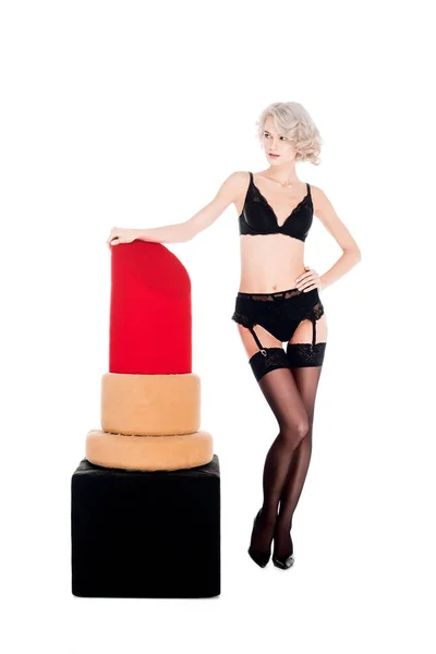 Attractive woman in lingerie putting her hand on big red lipstick isolated on white — Stock Photo