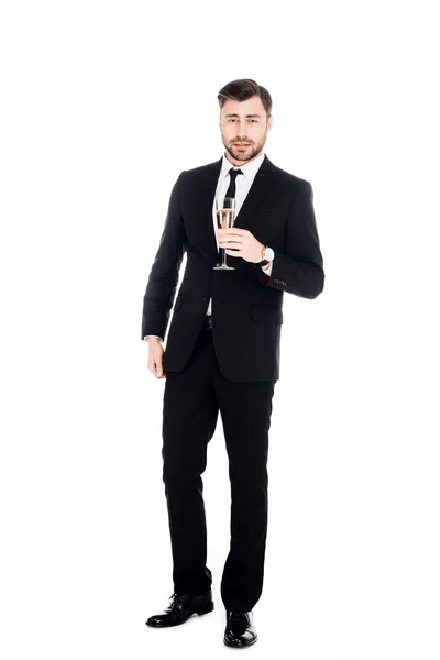 Bel homme en costume noir avec verre de champagne isolé sur blanc — Photo de stock