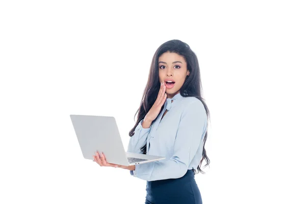 Shocked african american businesswoman holding laptop isolated on white — Stock Photo