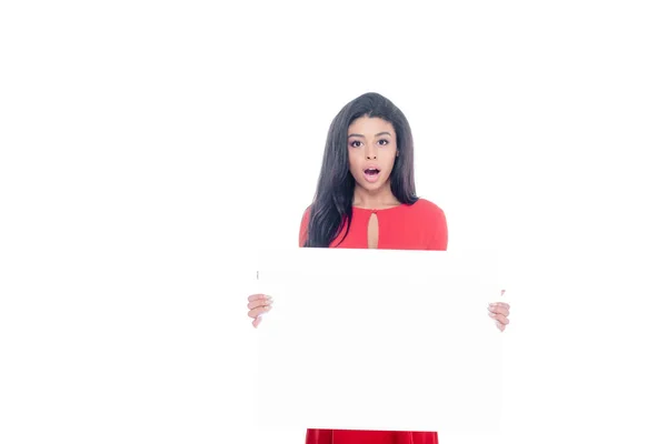Shocked african american girl in red dress showing empty banner isolated on white — Stock Photo