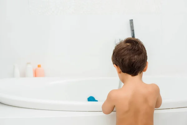 Naked toddler boy standing in white bathroom — Stock Photo