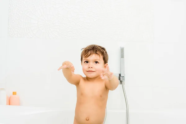 Small and cute boy gesturing in white bathroom — Stock Photo