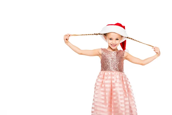 Adorable little child in santa hat stretching her tails and looking at camera isolated on white — Stock Photo