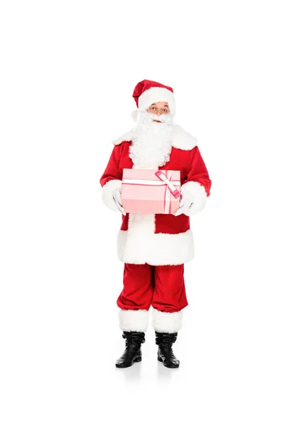 Emotional santa claus holding gift box and looking at camera isolated on white — Stock Photo