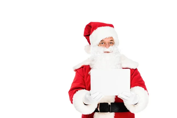 Santa claus holding laptop and looking at camera isolated on white — Stock Photo