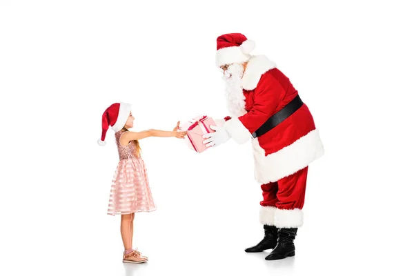 Vue latérale du Père Noël donnant cadeau à un petit enfant isolé sur blanc — Photo de stock