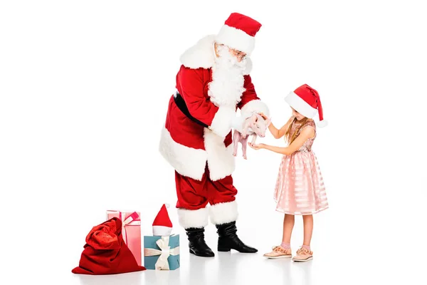 Santa claus giving piggy to little child isolated on white — Stock Photo