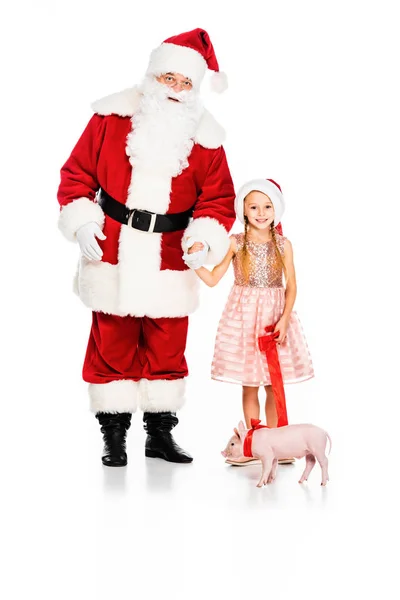 Santa claus y niño pequeño con correa cerdito aislado en blanco - foto de stock