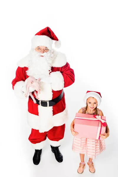 High angle view of santa holding pig and child holding present isolated on white — Stock Photo