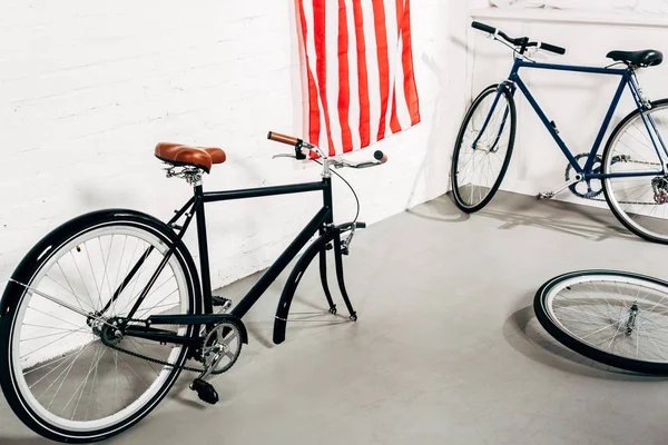 High angle view of disassembled bicycle near wheel in workshop — Stock Photo