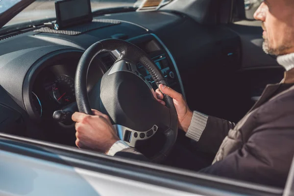 Man sitting and driving car in daytime — Stock Photo