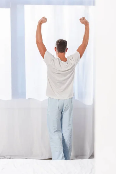 Back view of man stretching in room — Stock Photo