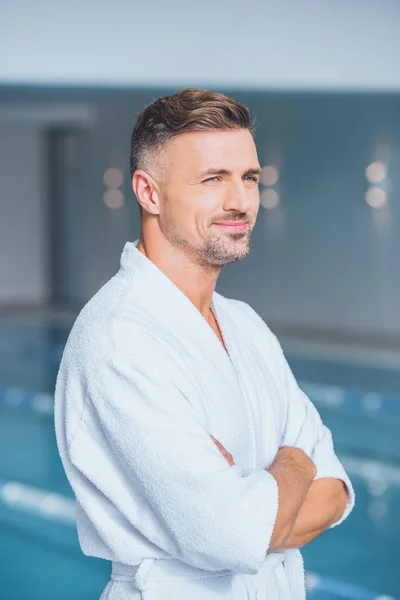 Handsome man standing in spa with crossed arms — Stock Photo