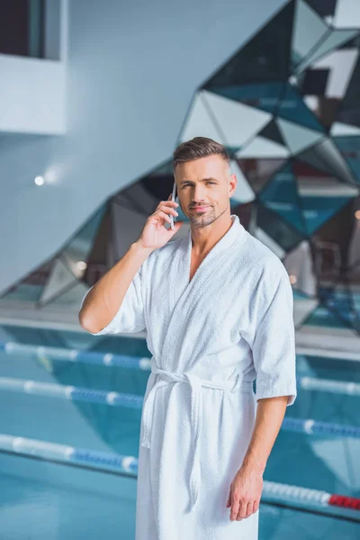 Handsome man talking on smartphone in spa — Stock Photo