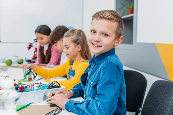 Schoolboy rejoicing making a robot during STEM robotics lesson — Stock Photo