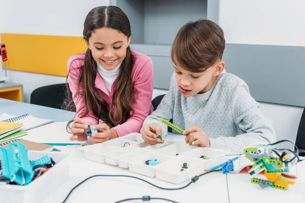 Schoolchildren working on robot at STEM robotics lesson — Stock Photo