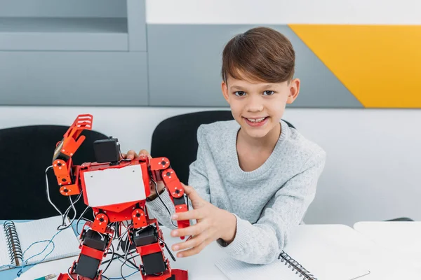 Schoolboy working with robot at STEM robotics lesson — Stock Photo