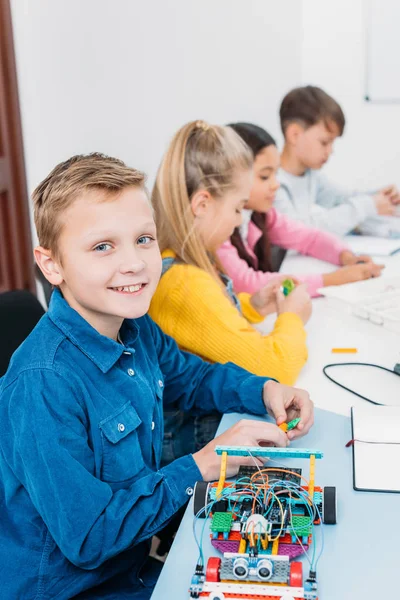 Preteen children sitting at desk in stem education class — Stock Photo